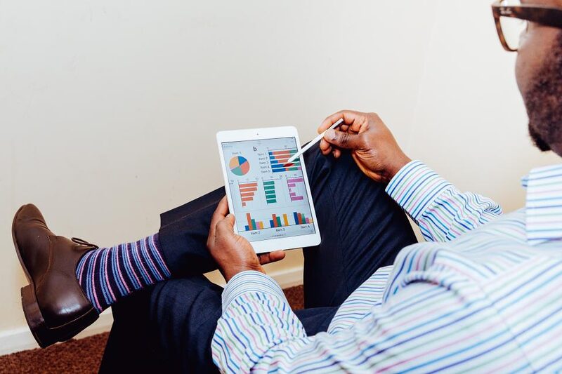 A person reviewing customer acquisition charts on a tablet